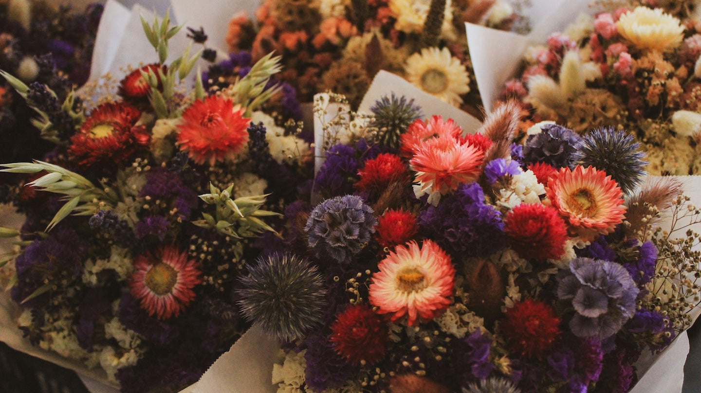 A bundle of market bouquets holding a variety of flowers for pressing