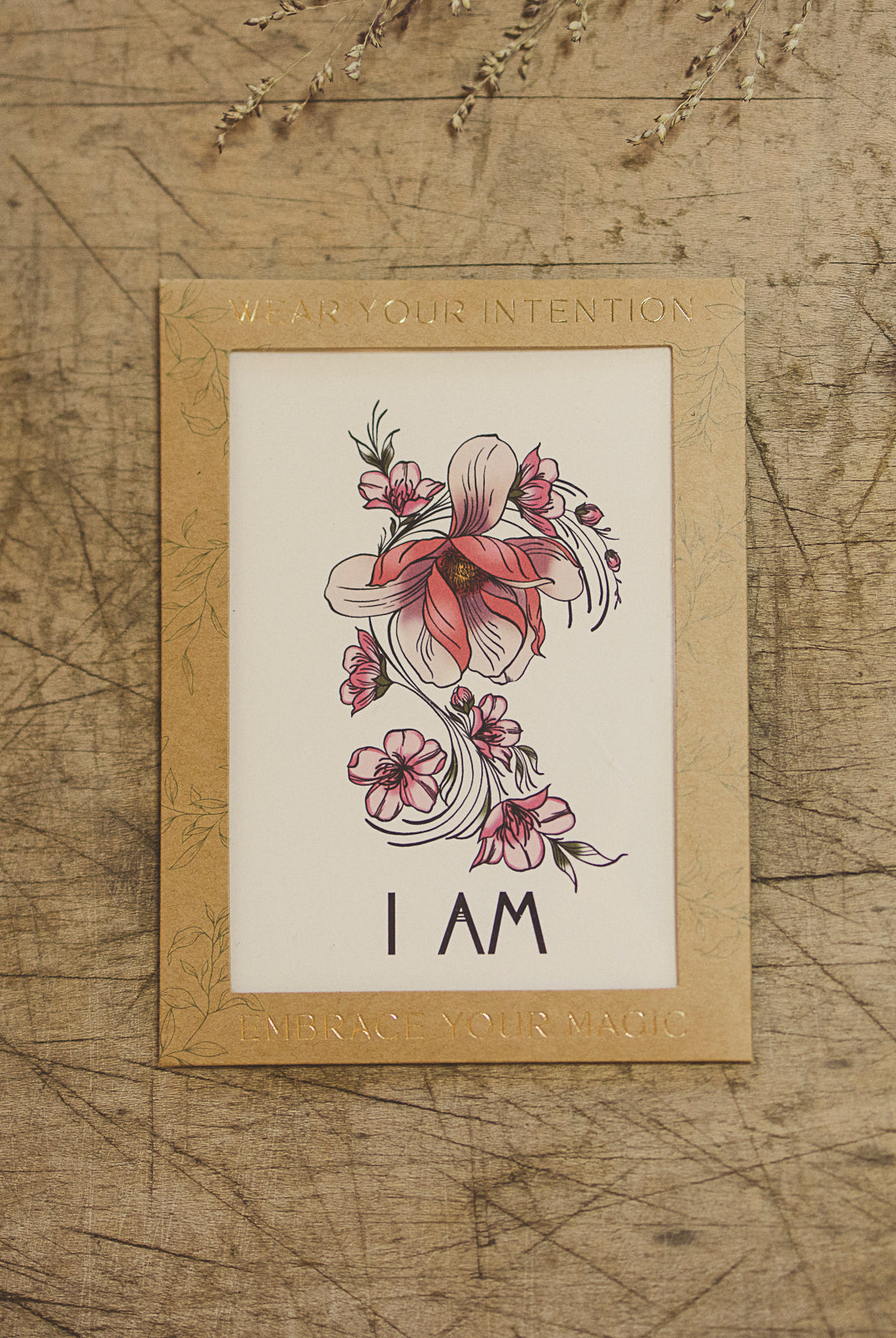 Detailed view of the "I Am" temporary tattoo script and fine magnolia flower illustration