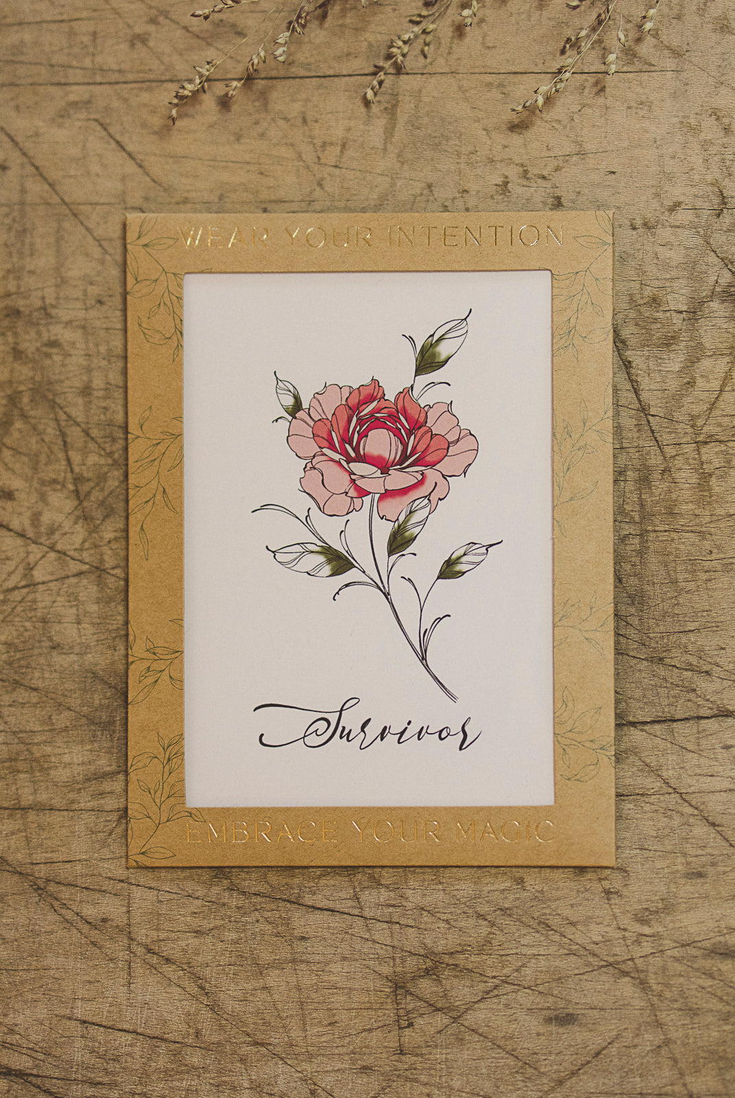 "Survivor" Peony flower temporary tattoo displayed on a table.