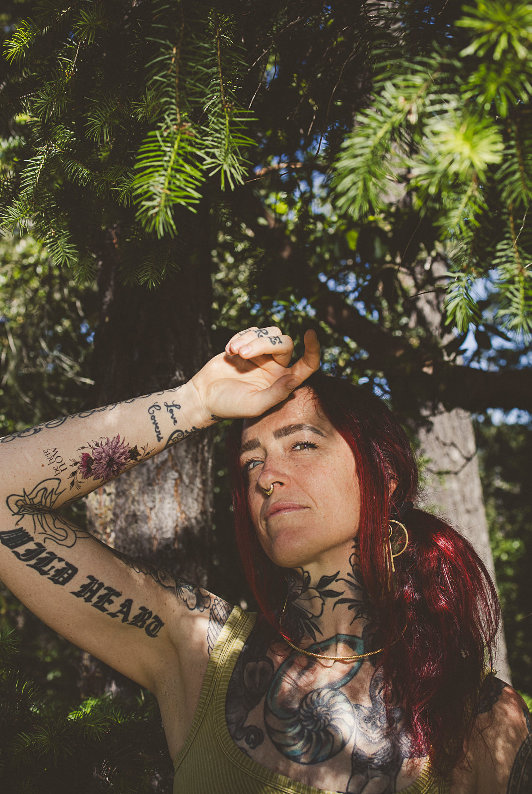Woman wearing a "Be Here Now" mindful temporary tattoo on her forearm