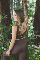 Woman wearing "I Am" temporary tattoo on her back, symbolizing self-acceptance
