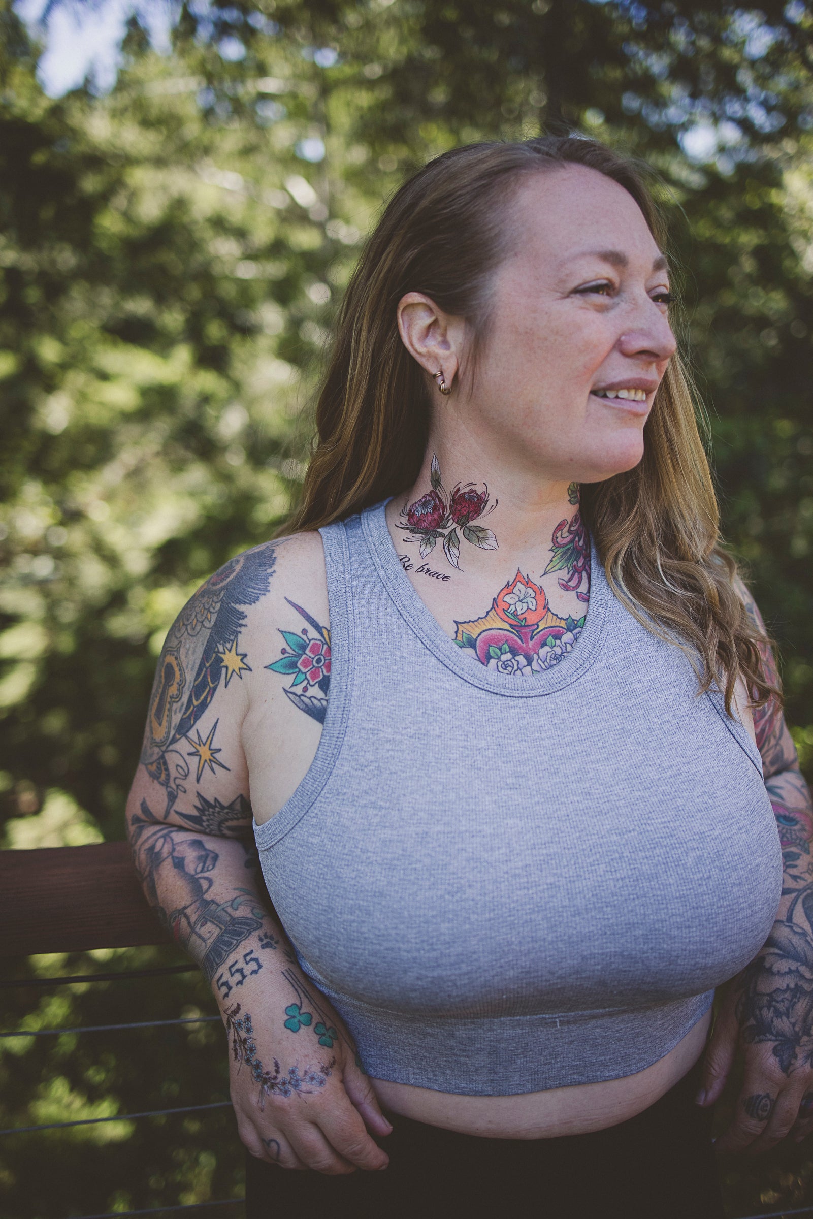 Person wearing a "Be Brave" botanical tattoo on their neck as a daily affirmation