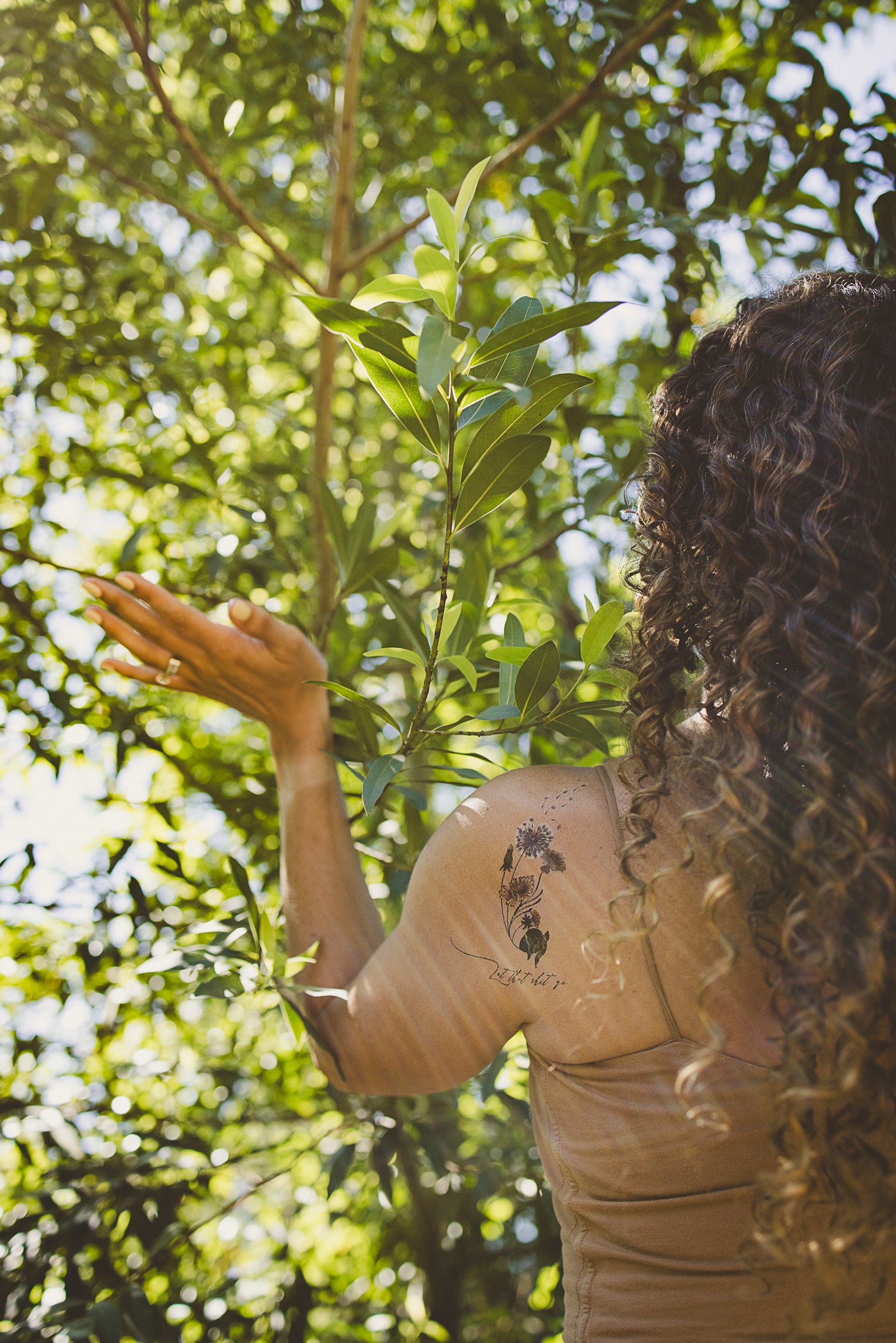 "Let That Shit Go" tattoo on skin for releasing negativity among nature.
