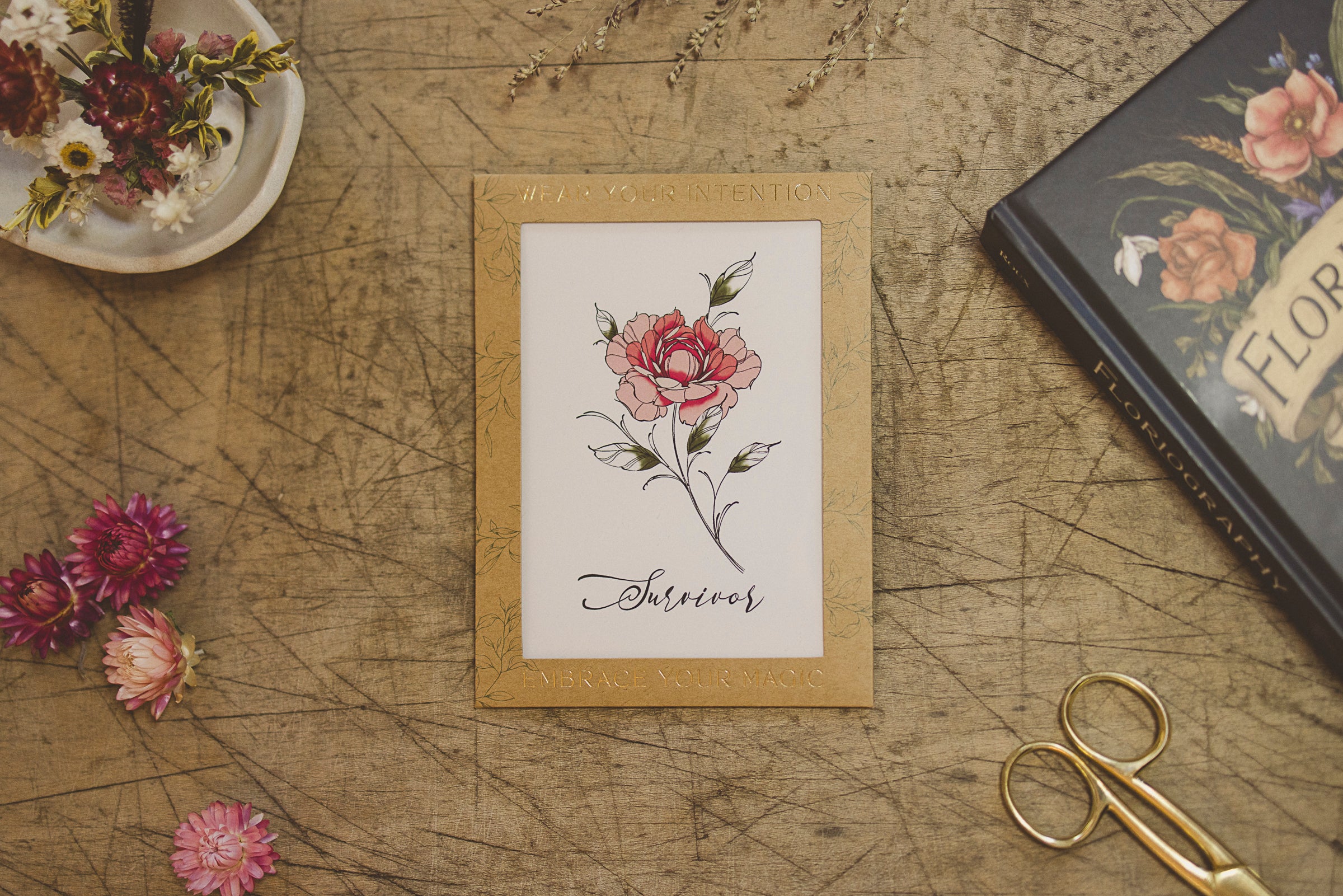 "Survivor" Peony flower temporary tattoo displayed on a table.