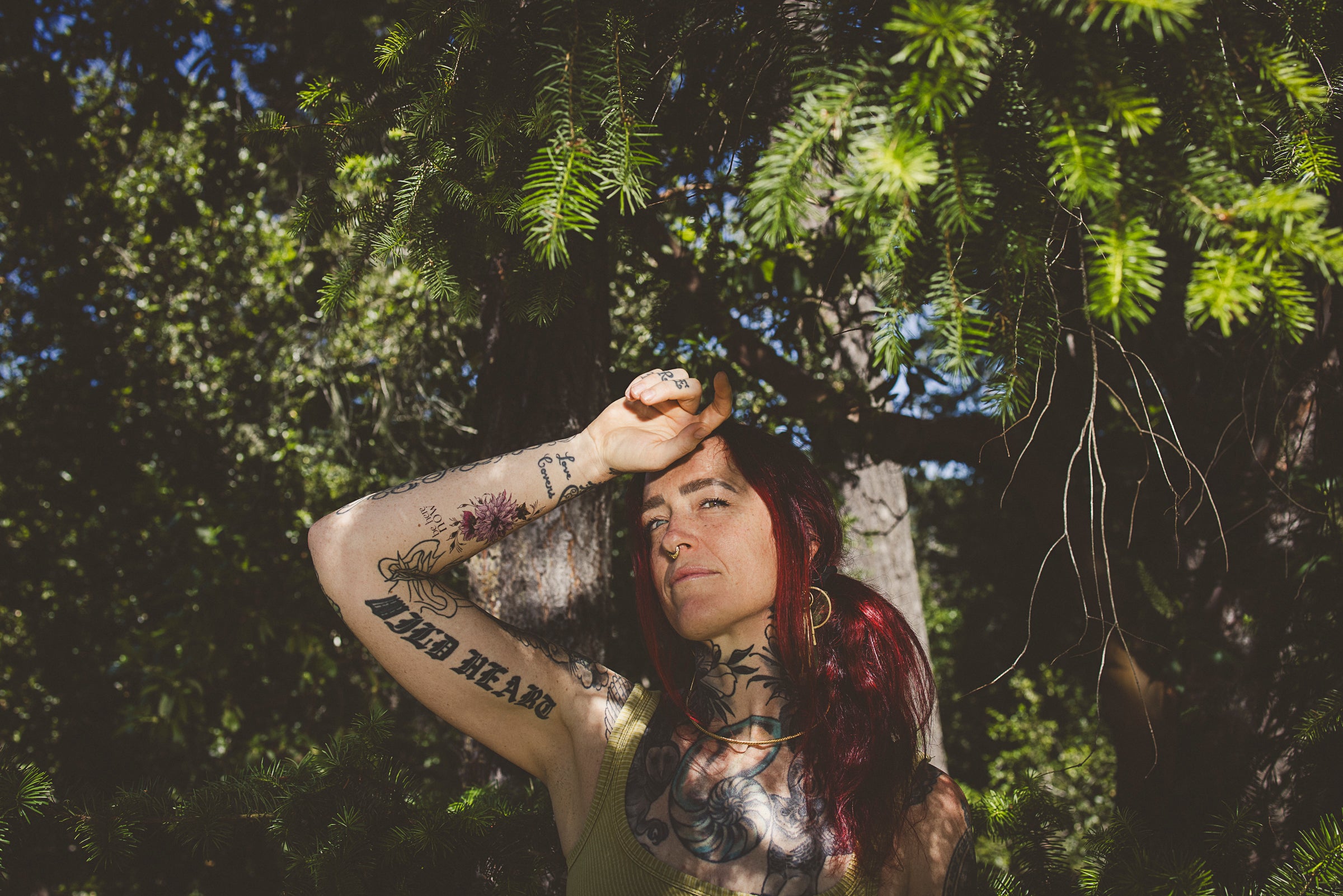 Woman wearing a "Be Here Now" mindful temporary tattoo on her forearm